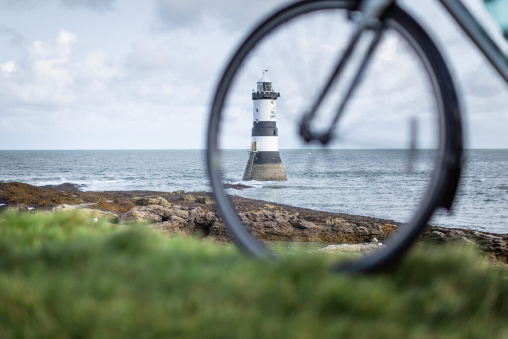 Penmon lighthouse, seen through bicycle wheel