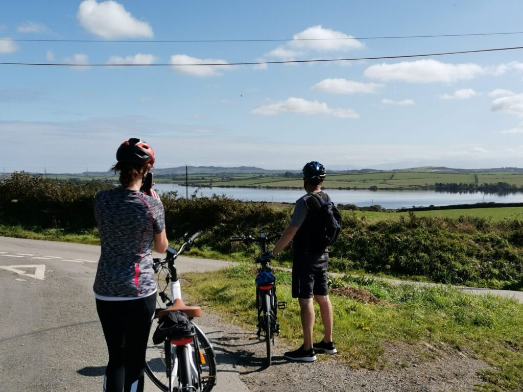 cyclists looking at Llyn Alaw, Anglesey